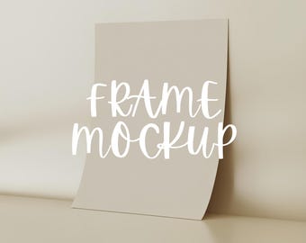 May include: A beige frame mockup with the text "FRAME MOCKUP" in white lettering.
