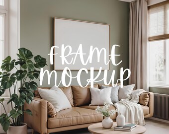 May include: A brown leather sofa with white throw pillows and a white blanket in a living room with a large framed picture on the wall, a green plant in a pot, and a coffee table with a vase of flowers and books.