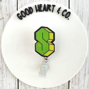 May include: A set of three ceramic mugs with a speckled, matte finish. The mugs are in shades of cream, light gray, and dark gray. Each mug has a simple, minimalist design and a rounded handle.