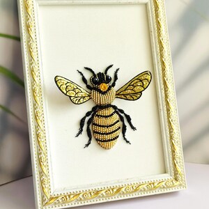 Bee lover gift showing a 3D textile art piece with shimmering white wing beads and a yellow crystal detail.