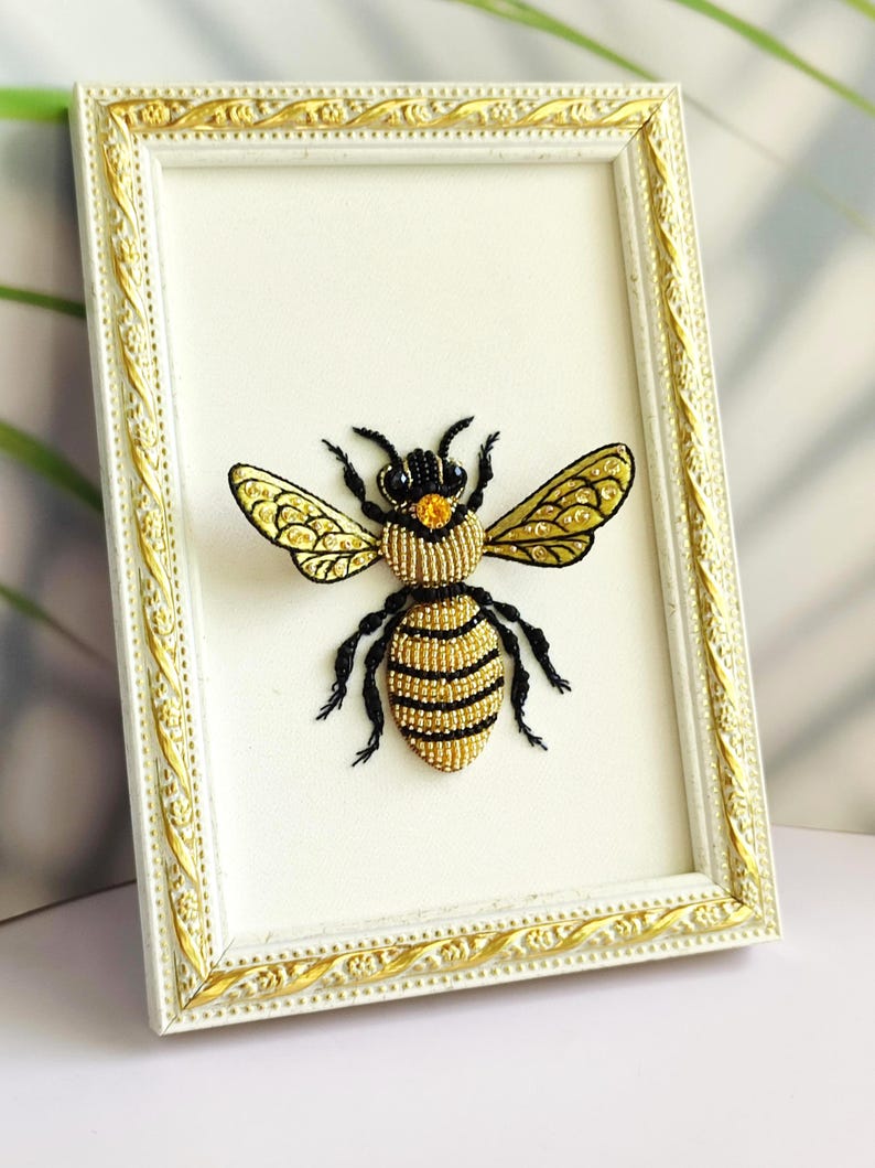Bee lover gift showing a 3D textile art piece with shimmering white wing beads and a yellow crystal detail.