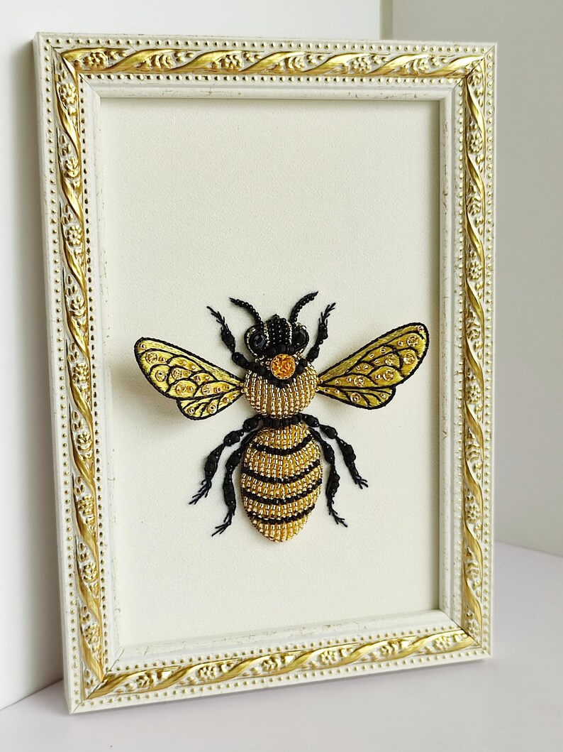 Forestcore decor artwork featuring a luxury hand-embroidered queen bee in a light-colored wooden frame.