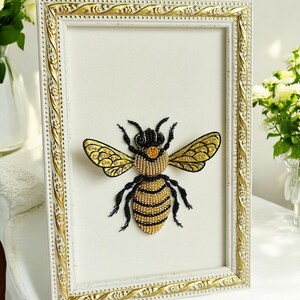 Ethical taxidermy display containing a handcrafted beaded insect