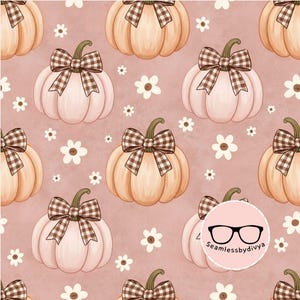 May include: A seamless pattern featuring light peach pumpkins with brown and white gingham bows and small white flowers on a dusty rose background. A circular logo with black eyeglasses and the text Seamlessbydivya is in the corner.