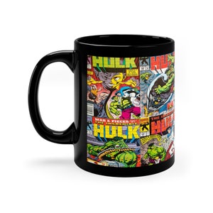 May include: Black ceramic coffee mug with a comic book design featuring the Incredible Hulk. The mug features a collage of comic book covers with the words "The Incredible Hulk" and "War & Pieces" on the covers.