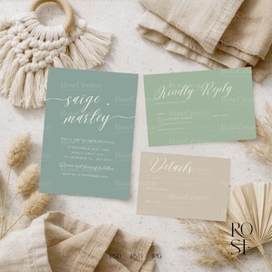 May include: A flat lay featuring wedding stationery. The set includes an invitation, RSVP card, and details card in muted green and beige tones. The invitation features the names "Saige & Marley" in elegant script. Dried flowers and fabric accents complete the aesthetic.