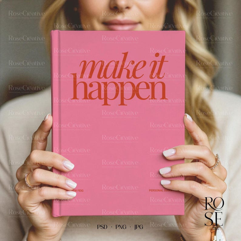 A lifestyle photograph of a woman softly smiling while holding a blank, cream-colored A5 hardcover book directly in front of her. She is holding the book with both hands, showcasing a delicate rose gold watch and rings. The lighting is soft and natural, creating a feminine, high-end aesthetic.