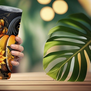 May include: A stainless steel tumbler with a fall-themed design featuring sunflowers, pumpkins, and butterflies. The tumbler has a black background with gold accents. The design wraps around the entire tumbler, creating a cohesive and decorative look.