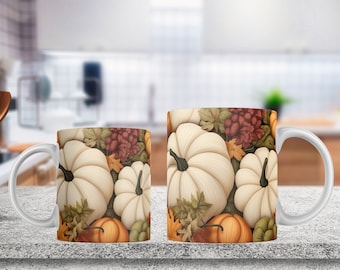 May include: Two white ceramic mugs featuring a repeating autumnal pattern of cream-colored pumpkins, orange pumpkins, and various fall-colored leaves in shades of green, brown, and yellow. Each mug has a curved white handle and a smooth cylindrical body.