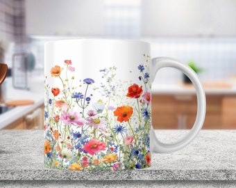 May include: White ceramic mug with a colorful floral design featuring red, orange, pink, yellow, blue, and green flowers. The mug has a white handle.