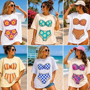 May include: A collection of six short-sleeved t-shirts featuring graphic prints of two-piece swimsuits. The designs include floral patterns, daisy motifs, orange and white stripes, blue and white checkerboard patterns, and tropical flower prints.