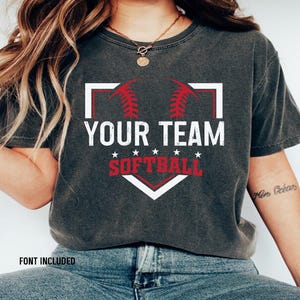 May include: A gray t-shirt with a white baseball diamond graphic. The graphic has red stitching and the text "Your Team Softball" in white.