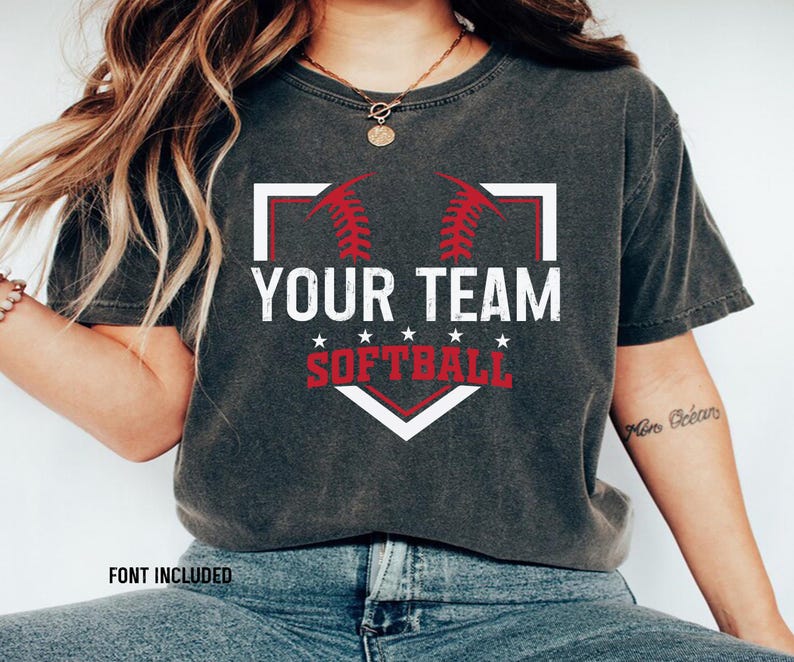 May include: A gray t-shirt with a white baseball diamond graphic. The graphic has red stitching and the text "Your Team Softball" in white.