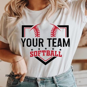 May include: White t-shirt with a black and white baseball diamond graphic. The graphic includes red stitching, two red baseballs, and the text "Your Team Softball".