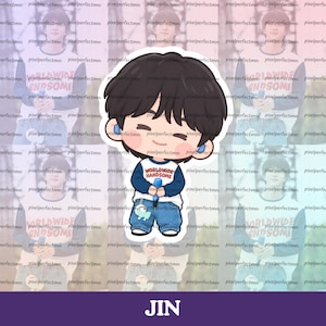 May include: A die-cut sticker featuring a cartoon illustration of a person with dark hair, wearing a white and navy blue long-sleeve shirt with the text WORLDWIDE HANDSOME printed in red, blue jeans, and holding a small blue microphone.