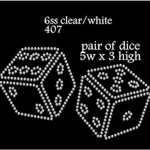 May include: A pair of silver dice made of rhinestones. The dice are 12.7 cm wide and 7.6 cm high. The text "6ss clear/white 407" is above the dice. The text "pair of dice 5w x 3 high" is below the dice.