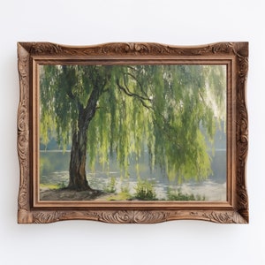 May include: A framed painting depicting a weeping willow tree with green foliage cascading over a tranquil body of water. The painting is set in a dark wood frame with intricate carvings.