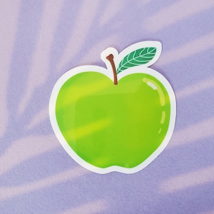 May include: A green apple sticker with a white outline and a green leaf on a purple background.