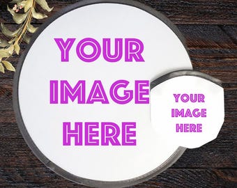 May include: A white, circular product with the text "YOUR IMAGE HERE" in bright pink. A smaller, matching product is attached. The background is a dark wood grain.