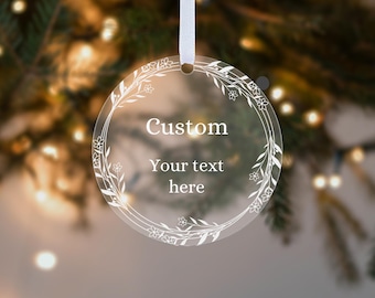 May include: Clear round ornament with a white floral design and the text "Custom Your text here".