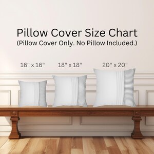 May include: Three white pillow covers with gray stripes, displayed on a wooden bench. The pillow covers are available in three sizes: 16 inches by 16 inches, 18 inches by 18 inches, and 20 inches by 20 inches.