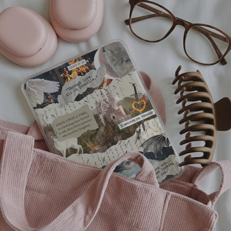 May include: A clear tablet case featuring a collage of fantasy-themed imagery including a castle, a sword, a deer, and text snippets like "Through love, all is possible." The case is placed inside a pink corduroy tote bag with pink headphones and brown glasses.