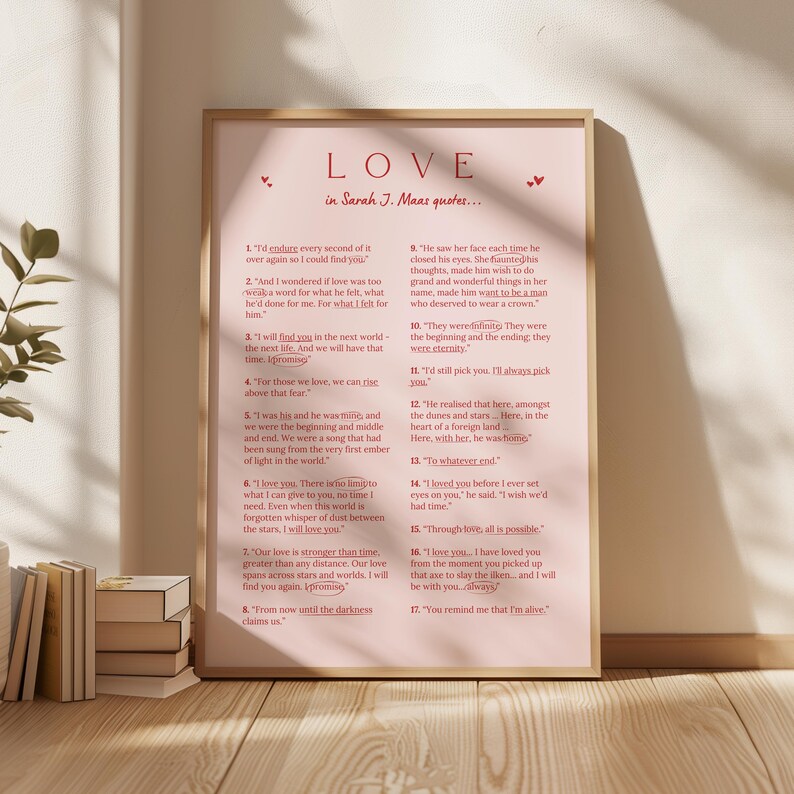 May include: A framed print with a pink background features quotes from Sarah J. Maas's books in red text. The word "LOVE" is at the top, with small heart accents. The quotes are numbered and arranged in a vertical format.