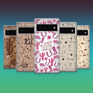 Op de afbeelding: Vijf telefoonhoesjes met een Western-thema. De hoesjes hebben verschillende ontwerpen, waaronder cactussen, paarden en cowboylaarzen. Eén hoesje heeft de tekst "Yee Haw" met roze accenten. De hoesjes zijn in tinten bruin, beige en wit.