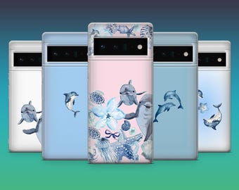 May include: A collection of five phone cases with aquatic-themed designs. The cases feature illustrations of dolphins, starfish, and seashells in shades of blue and white against a light blue and pink background. The cases are designed for a smartphone.