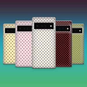 May include: Five smartphone cases arranged in a row, each featuring a consistent white polka dot pattern. The cases are displayed in various colours including light yellow, light pink, white, dark maroon, and olive green, all with a black camera bar.
