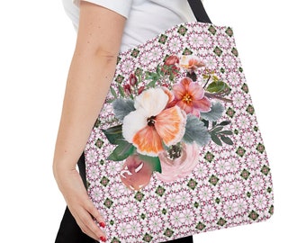 May include: A white tote bag with a floral pattern. The bag features a large bouquet of pink, orange, and white flowers with green leaves on a white background with a pink and green geometric pattern.