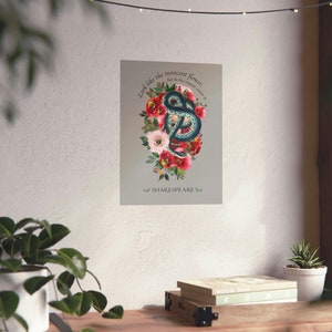 May include: A digital art print featuring a green snake coiled around red and pink flowers. The quote "Look like the innocent flower, but be the serpent under it" by Shakespeare is printed below the image.