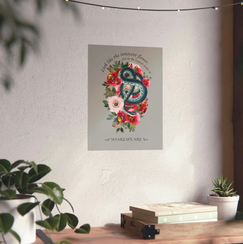May include: A digital art print featuring a green snake coiled around red and pink flowers. The quote "Look like the innocent flower, but be the serpent under it" by Shakespeare is printed below the image.