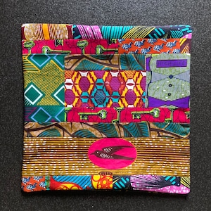 May include: A colorful patchwork fabric pouch with a bird design and the text "HIGH LIFE" in a white circle. The pouch is made of different fabrics with geometric patterns and a variety of colors, including red, green, blue, yellow, and brown.