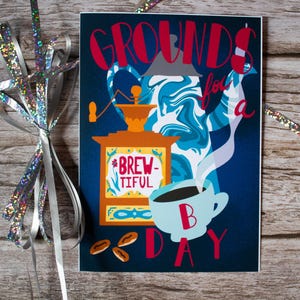 May include: A coffee-themed art print with the words "GROUNDS for a DAY" in red script. The print features a coffee grinder, a coffee pot, and a cup of coffee. The background is a dark blue with a wood grain texture.