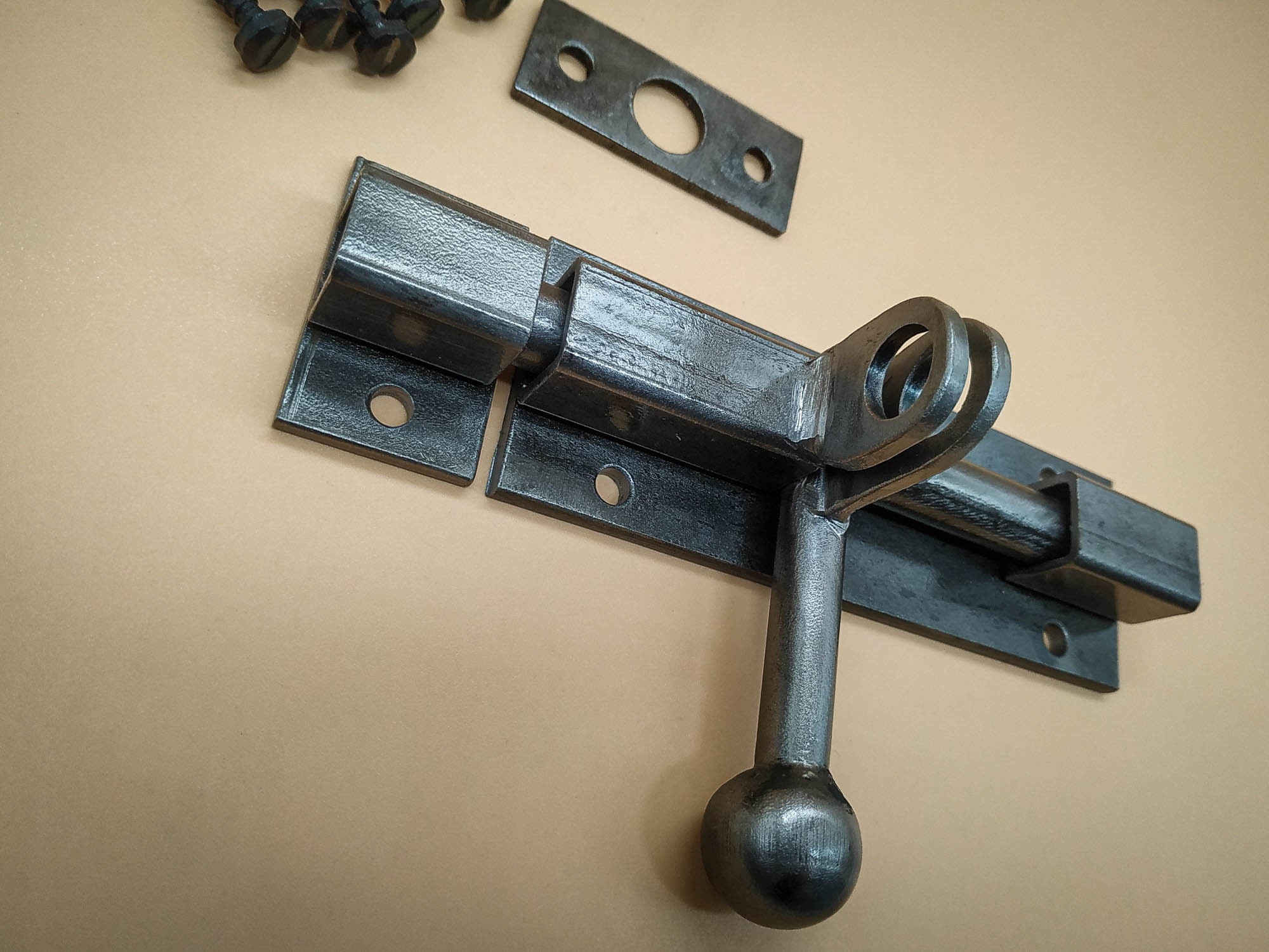 An Industrial Door Latch, Handcrafted From Steel in a Rustic Style
