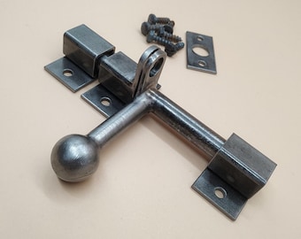 A door latch, handcrafted in a rustic style, ensures reliable and easy closure of doors.