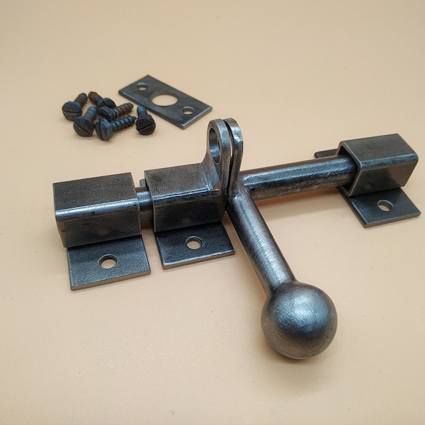 A door latch, handcrafted in a rustic style, ensures reliable and easy closure of doors.