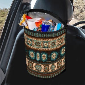 May include: Car seat organizer with a southwestern pattern in brown, teal, and beige. The insulated bag is filled with snacks and drinks, including a white cup and a blue can. The bag hangs from the back of a car seat.