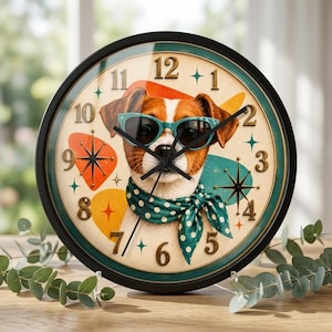May include: A round wall clock with a black frame featuring a central illustration of a brown and white dog wearing teal sunglasses and a teal polka-dot neckerchief. The clock face has gold-colored numbers and colorful mid-century starburst accents.