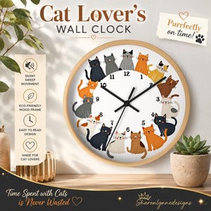 May include: A round wall clock with a light wood frame featuring a white face decorated with twelve illustrated cats in various colors. The clock has black hands and black numbers. Text on the clock includes Cat Lover's WALL CLOCK and Purrfectly on time!