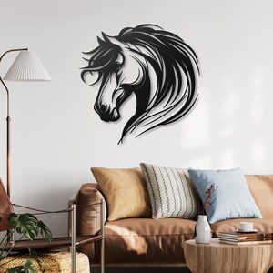 May include: Black metal wall art featuring a horse's head with flowing mane. The horse is facing left and has a detailed design. The art is mounted on a white wall above a brown couch with pillows.