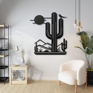 May include: Black metal wall art depicting a desert scene with a large cactus, mountains, and a small bird perched on top. The sun is represented by a black circle.