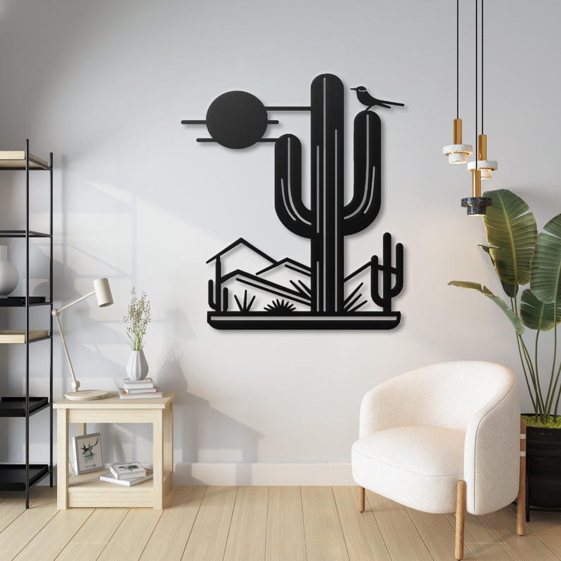 May include: Black metal wall art depicting a desert scene with a large cactus, mountains, and a small bird perched on top. The sun is represented by a black circle.