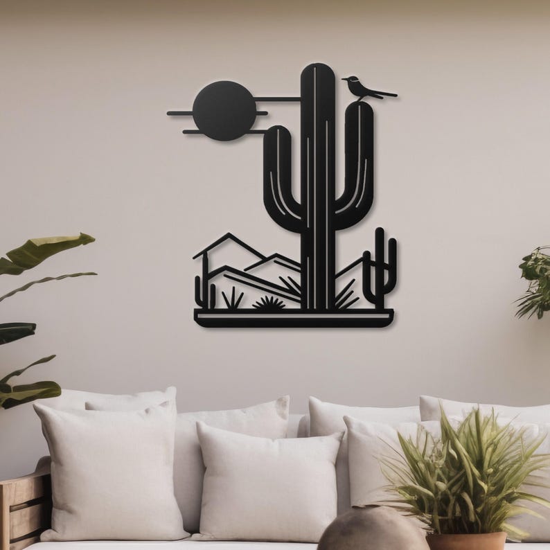 May include: Black metal wall art depicting a desert landscape with a large saguaro cactus, mountains, and a bird perched on the cactus. The sun is represented by a black circle.