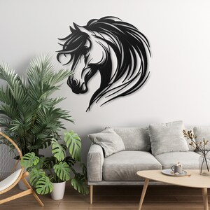 May include: Black metal wall art featuring a horse's head with flowing mane. The horse is facing left and has a detailed design.