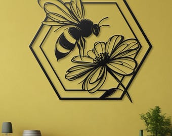 May include: Black metal wall art featuring a bee and flower design inside a hexagonal frame. The bee is stylized and has black and yellow stripes. The flower is a simple design with five petals.