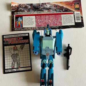 Autobot flou vintage Transformers G1 avec dos de carte pistolet et instructions Hasbro Decepticon