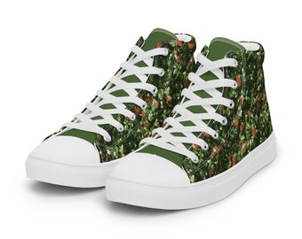 May include: A pair of high-top canvas sneakers with a green and orange camouflage pattern. The shoes have white laces and a white sole.