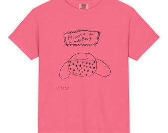 May include: A pink Comfort Colors t-shirt featuring a hand-drawn ladybug design with the text "Phoenix da LadyBug." The illustration includes a ladybug with black spots and the name "Milo" written below the design.